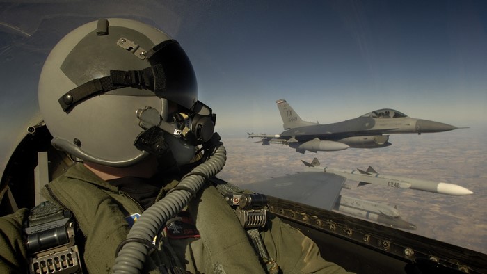 Pilot in F-16 cockpit with wingmen flying