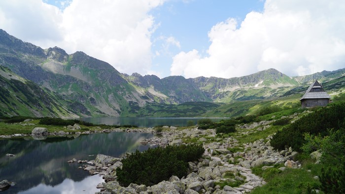 Mountain lake with a wooden cabin in the Tatra Mountains, Poland