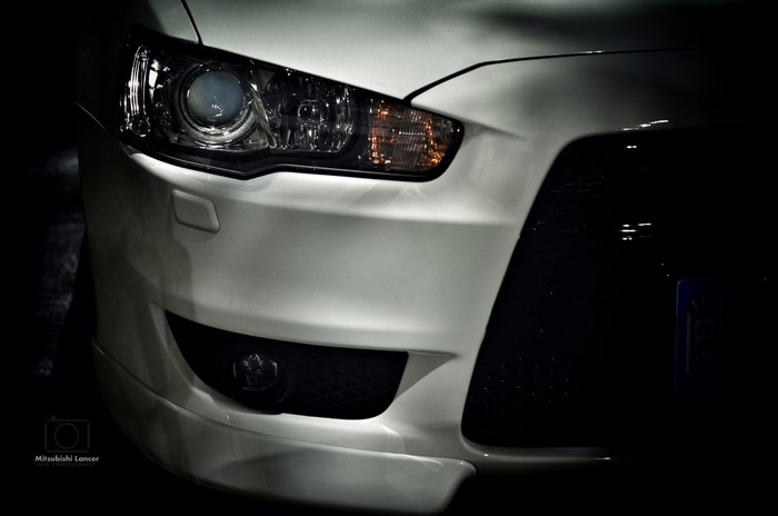 Front view of a white Mitsubishi Lancer
