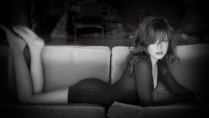 Emma Stone Lying on Couch in Black Dress