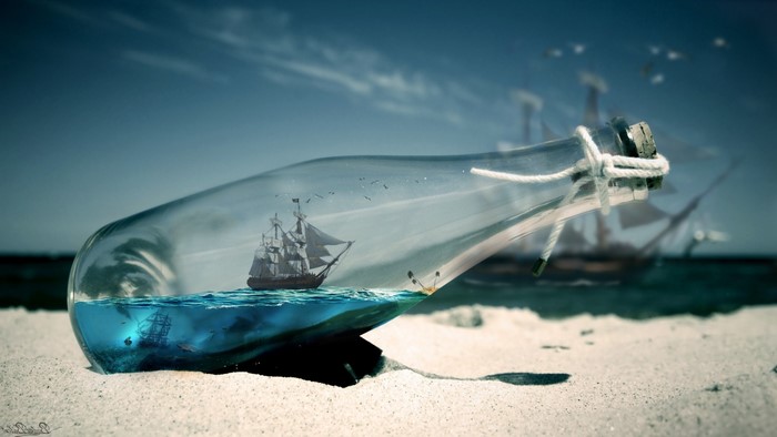 Ship in a bottle on a sandy beach