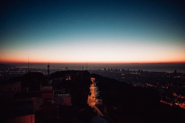 Cityscape at dusk with a road and lights
