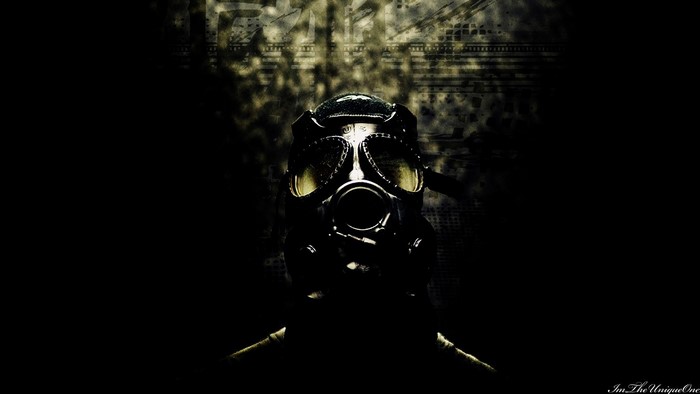 Person wearing a gas mask in dark environment