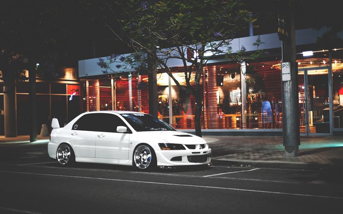 White Mitsubishi Lancer Evolution parked at night