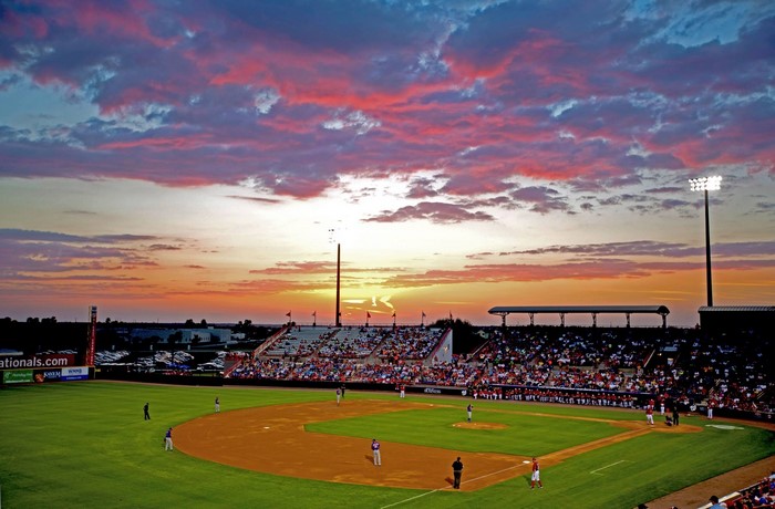 Baseball stadium at sunset with colorful clouds