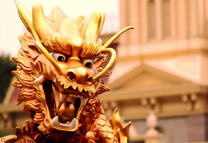 Golden Chinese Dragon Statue with Building Background