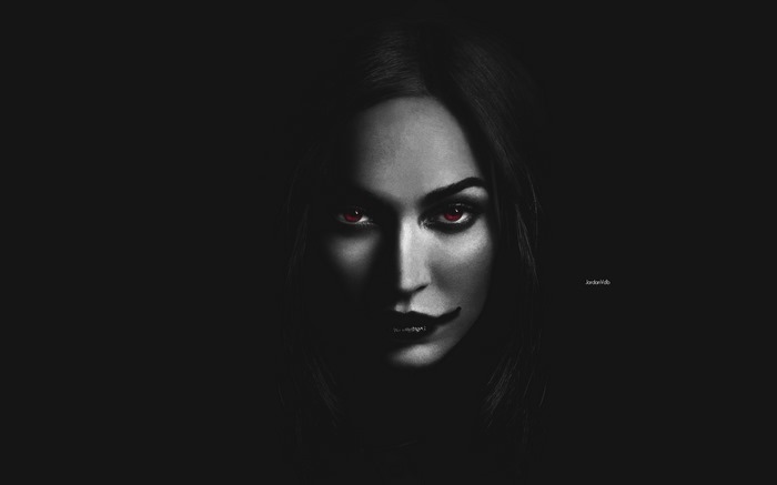 Woman with red eyes in darkness