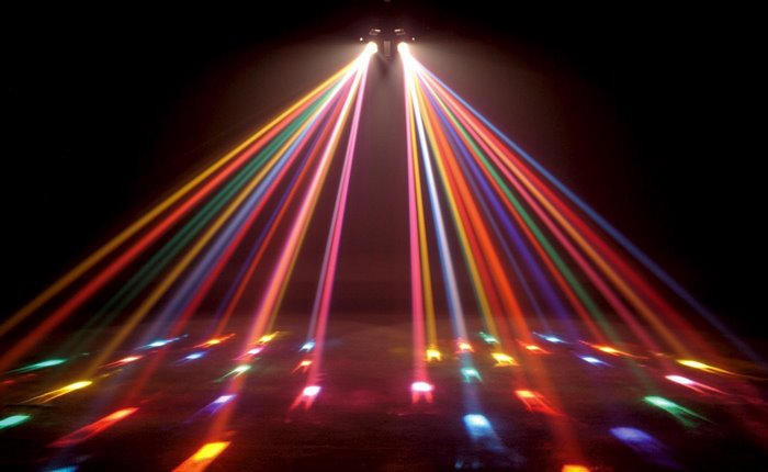 Colorful disco lights shining down on a dark floor