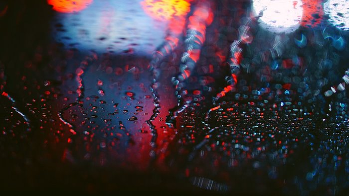 Raindrops on glass with bokeh lights