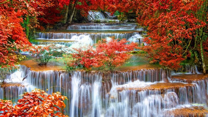 Multi-tiered waterfall with red foliage