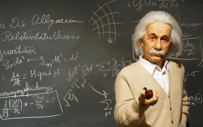 Albert Einstein with equations on a blackboard