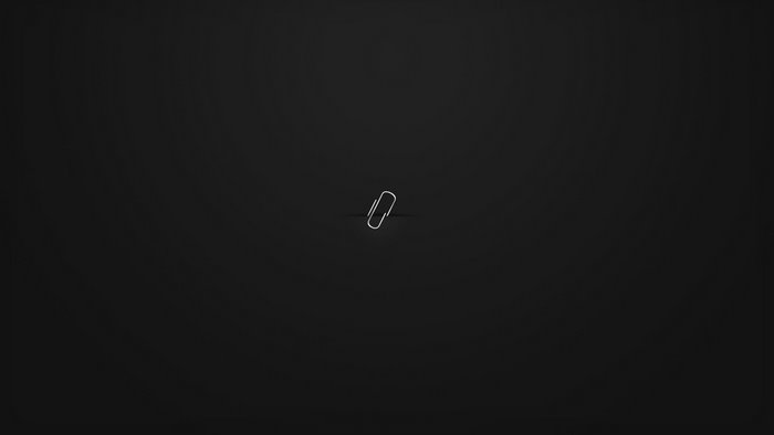 Minimalist paperclip on black background