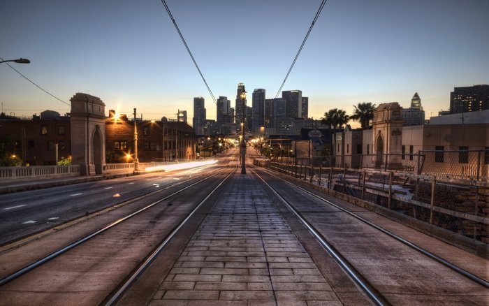 Los Angeles cityscape at sunrise with tram tracks