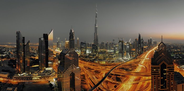 Dubai cityscape with Burj Khalifa and highway at night