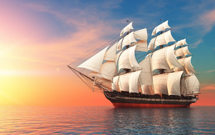 Sailing ship on the sea at sunset