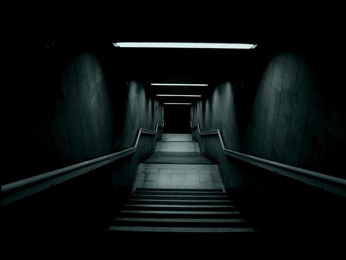 Dark underground stairs with fluorescent lights