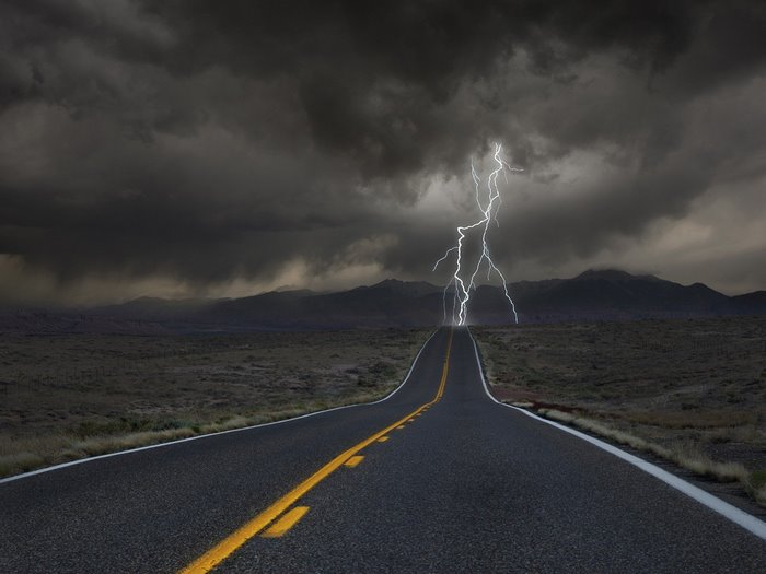 Road with lightning strike during a storm