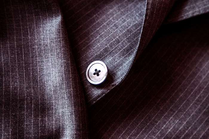 Close-up of a pinstripe suit jacket button
