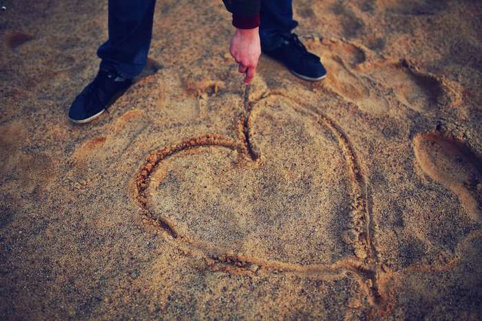 Heart drawn in sand on a beach