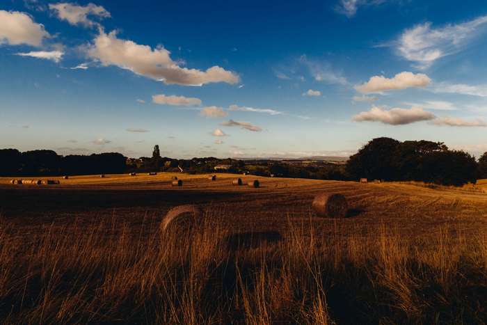 Hay bales in a rural field at sunset 4K