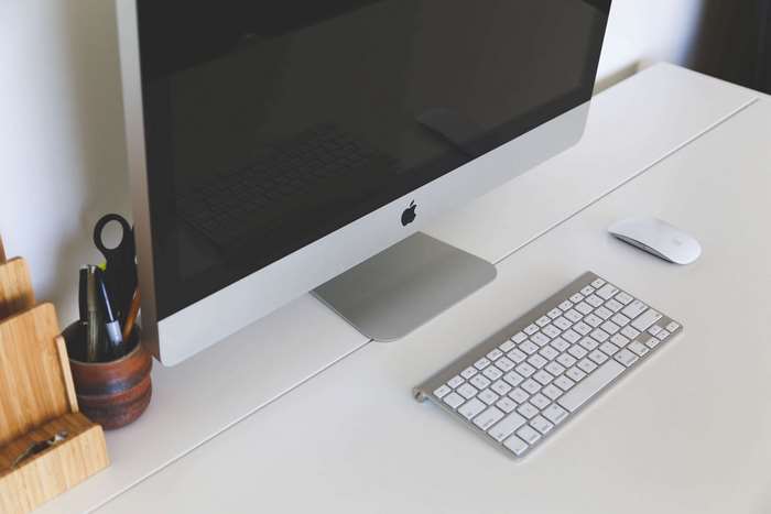 Apple iMac computer with keyboard and mouse on desk