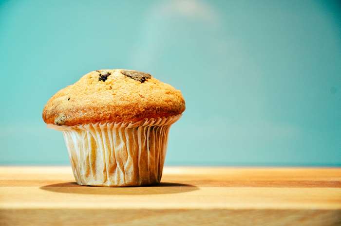 Chocolate chip muffin on a wooden surface