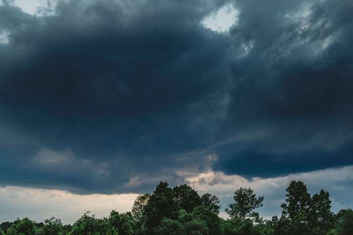 Dark storm clouds over a forest