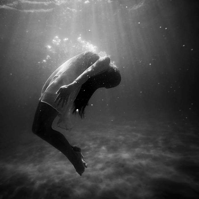 Woman underwater in a dress