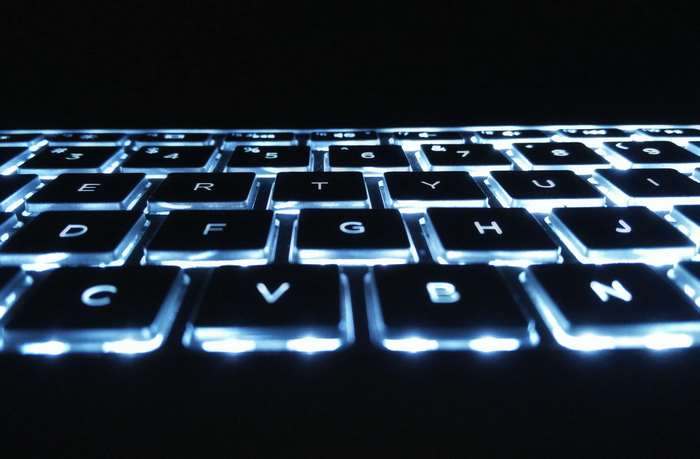Backlit keyboard with blue lights, macro shot
