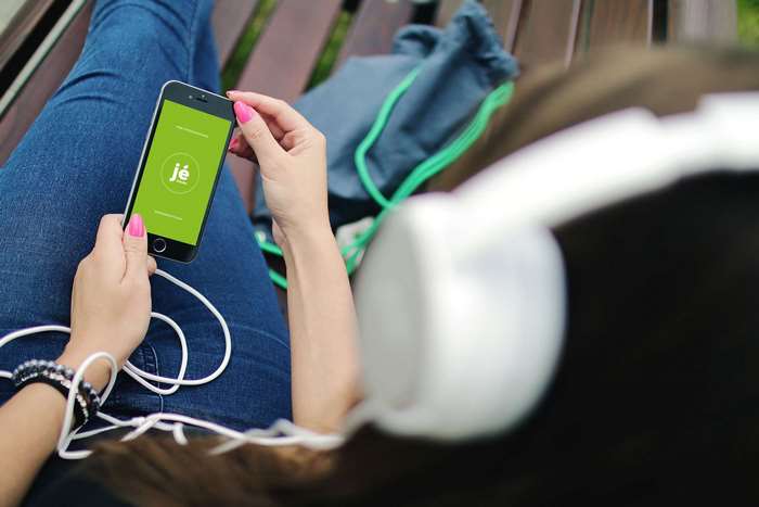 Woman holding iPhone 6 with headphones