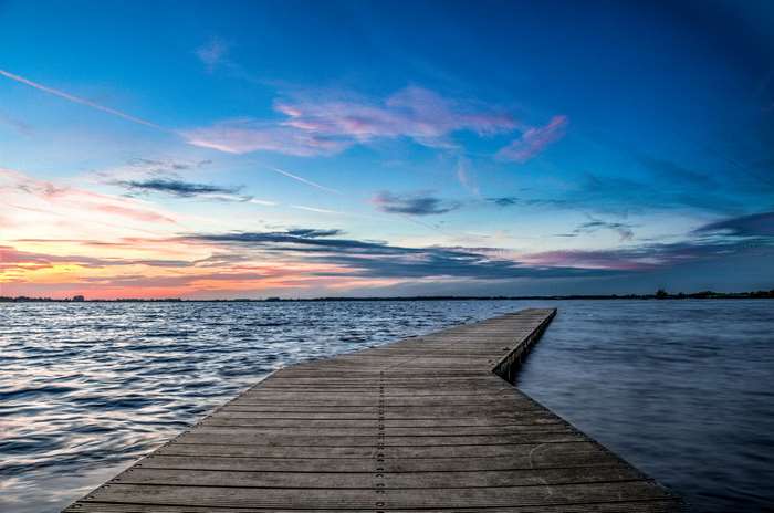 Wooden jetty on a lake at sunset 4K