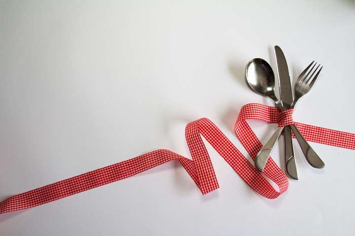 Cutlery tied with red and white ribbon