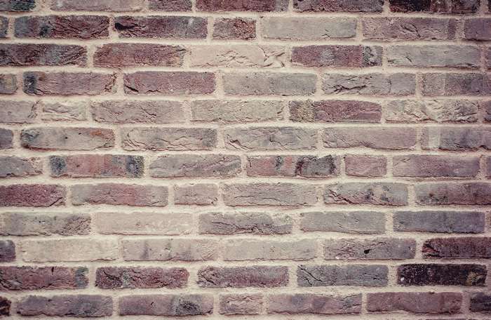 Close-up of a weathered brick wall texture