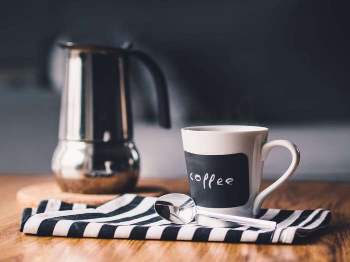 Coffee cup and moka pot on a table