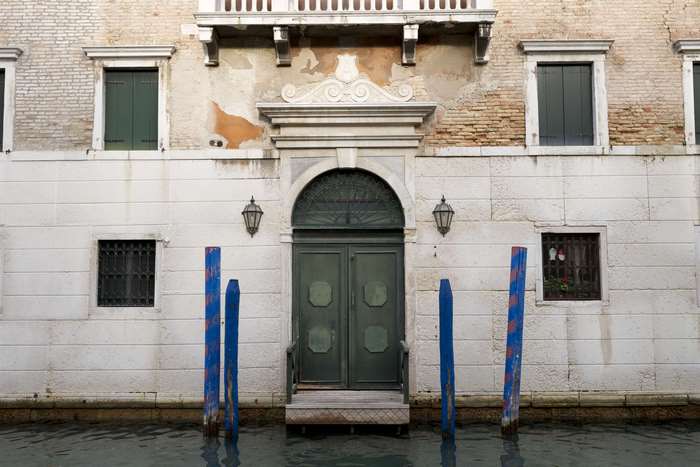 Venice building with doors and windows on a canal