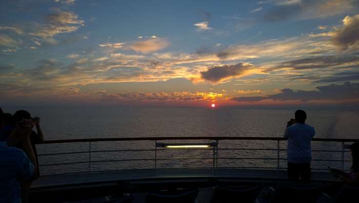 Sunset over the ocean from a cruise ship deck