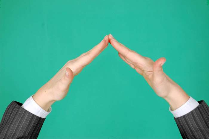 Hands forming a roof shape