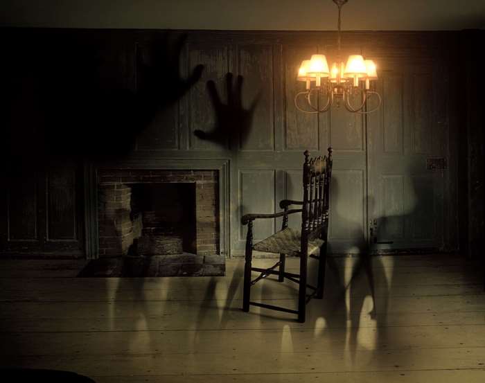 Spooky room with shadows and a chair
