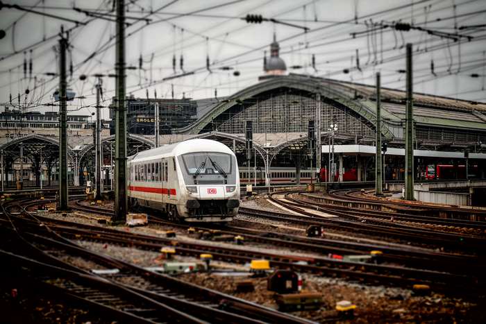 Train station with DB train and railway tracks