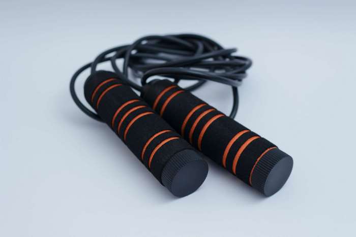 Skipping rope with black and orange handles