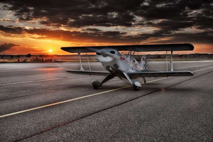 Biplane on runway at sunset 4K
