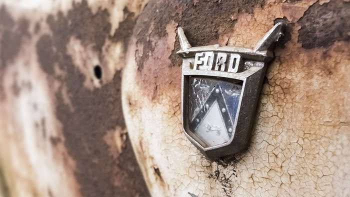 Ford emblem on a rusty old car