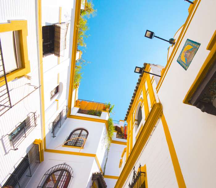 White and yellow buildings in a Spanish alley