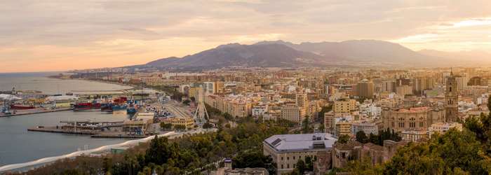 Panoramic view of Malaga city and port at sunset