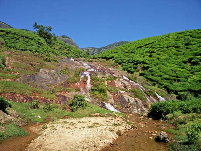 Waterfall cascading through tea plantations in Munnar, Kerala 4K
