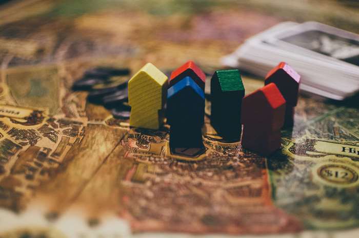 Board game pieces on a map with cards