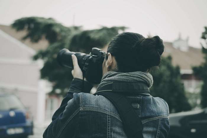 Woman with camera taking a photo