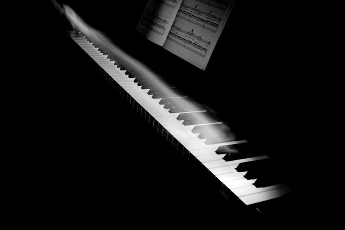 Motion blur over piano keys with sheet music