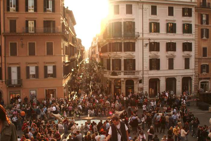 Crowd of people in a European city street with buildings