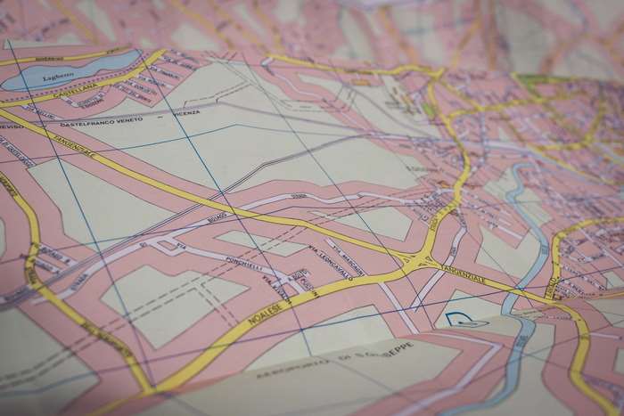 Close-up of a folded paper map of Italy with roads and towns